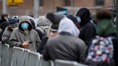 FILE PHOTO: People wait in line to be tested for Covid-19 while wearing protective gear, outside Elmhurst Hospital Center in  New York City, the US' major coronavirus epicenter.