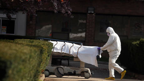 FILE PHOTO: A healthcare worker wheels the body of deceased people from a Brooklyn hospital during the coronavirus outbreak in New York City.