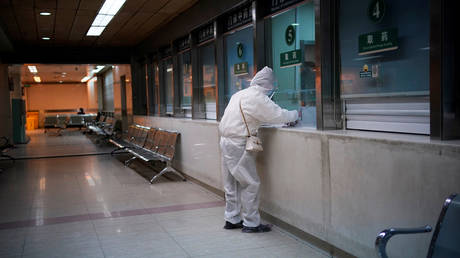 FILE PHOTO. A woman wearing protective suit is seen at a hospital after the lockdown was lifted in Wuhan.