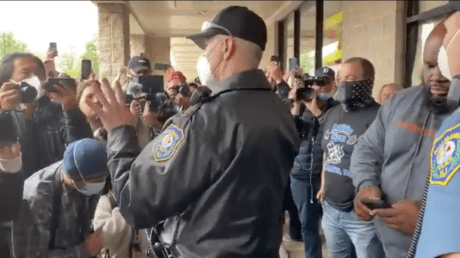 Police speak to protestors outside Atilis Gym in New Jersey
