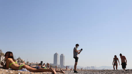 People enjoy the sunny weather at Barceloneta beach in Barcelona this week. © REUTERS/Nacho Doce