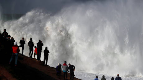 Daredevil surfer miraculously rescued between waves after wipeout on Portugal's Nazare coast (VIDEO)