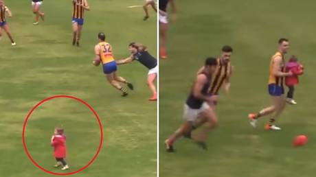 Stray toddler rescued by Aussie footballer after running onto pitch during game (VIDEO)